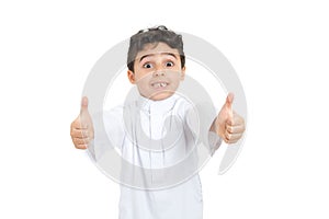 Arab 8 years old kid giving two thumbs up with big smile photo