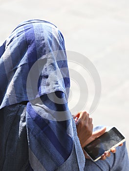 Arab young woman with veil and smart phone