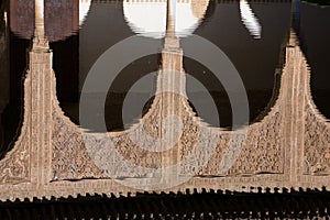 Arabesque arches reflection in the mirror of water. Alhambra of Granada photo