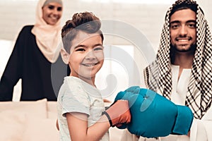 Arabian Boy Boxing with Young Father at Home.