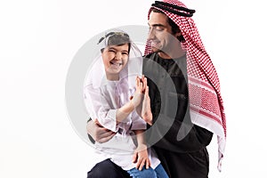 Arabian boy gives five fathers in keffiyeh.