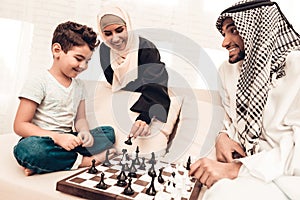 Arabian Boy Playing Chess with Father at Home