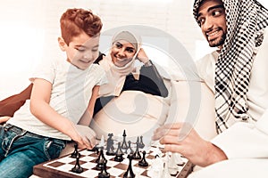 Arabian Boy Playing Chess with Father at Home.