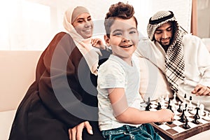 Arabian Boy Playing Chess with Father at Home