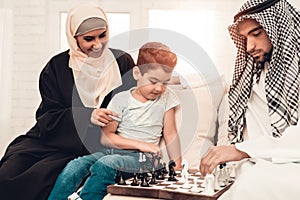 Arabian Boy Playing Chess with Father at Home