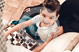 Arabian Boy Playing Chess with Father at Home.