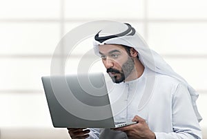 Arabian Business man looking surprised at his laptop