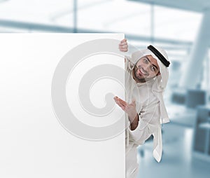 Arabian business man pointing at a blank sign