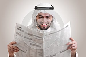 Arabian business man reading newspaper