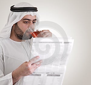 Arabian business man reading newspaper