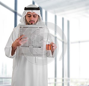 Arabian business man reading newspaper