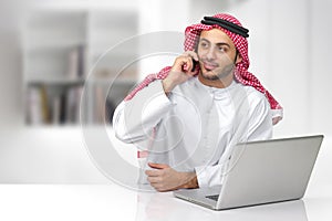 Arabian business man talking on phone in his office