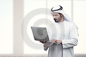 Arabian Business man using notebook in a modern office