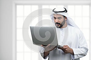 Arabian Business man using notebook in a modern office