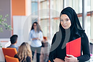 Arabian business woman with hijab holding a folder