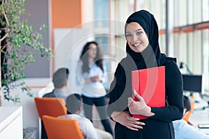 Arabian business woman with hijab holding a folder