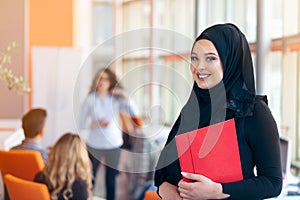 Arabian business woman with hijab holding a folder