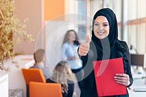 Arabian business woman with hijab holding a folder