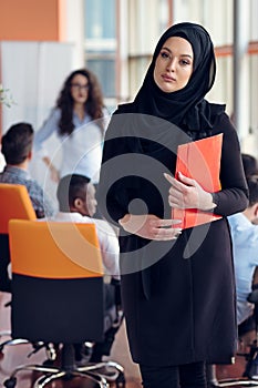 Arabian business woman with hijab holding a folder