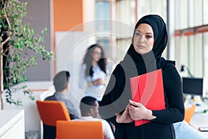 Arabian business woman with hijab holding a folder