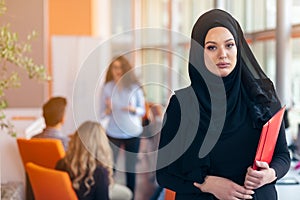 Arabian business woman with hijab holding a folder