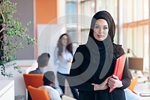 Arabian business woman with hijab holding a folder