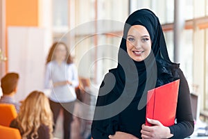 Arabian business woman with hijab holding a folder