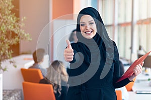 Arabian business woman with hijab holding a folder