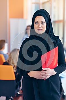 Arabian business woman with hijab holding a folder