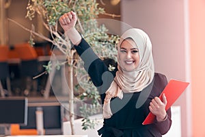 Arabian business woman holding a folder in modern startup office