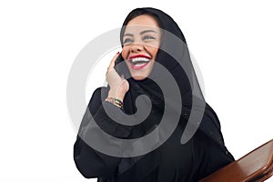 Arabian business woman holding a folder and talking on the phone isolated on white