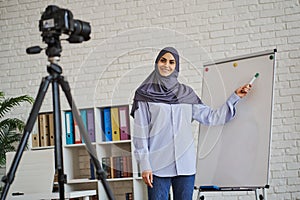 Arabian business woman making a video with an explanation