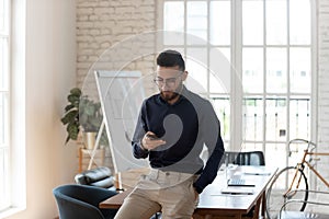 Arabian businessman busy using modern smartphone in office