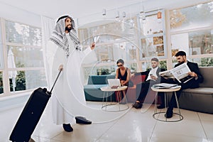 Arabian Businessman Holding A Suitcase In Office.