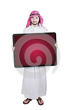 Arabian businessman holds empty board on studio
