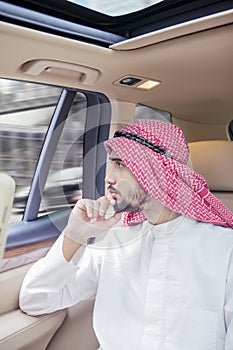 Arabian businessman looking out the car window