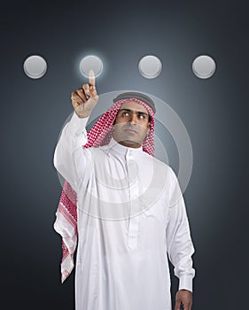 Arabian businessman pressing a touchscreen button