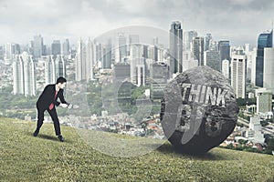 Arabian businessman pulling text of think big photo