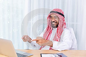 Arabian businessman smile and happy from message his computer notebook in his office