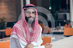 Arabian businessman working in modern startup office