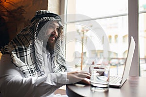 Arabian businessman working in office, business centre using devicesm gadgets. Lifestyle