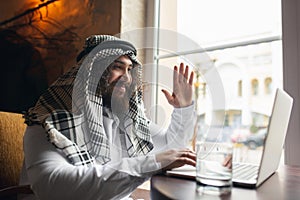 Arabian businessman working in office, business centre using devicesm gadgets. Lifestyle