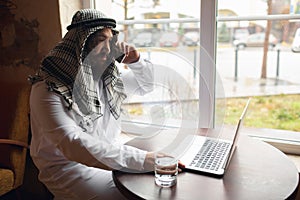 Arabian businessman working in office, business centre using devicesm gadgets. Lifestyle