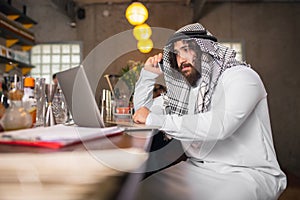 Arabian businessman working in office, business centre using devicesm gadgets. Lifestyle