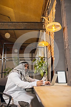 Arabian businessman working in office, business centre using devicesm gadgets. Lifestyle