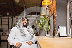 Arabian businessman working in office, business centre using devicesm gadgets. Lifestyle