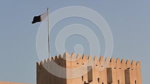 arabian castle tower with Qatar flag