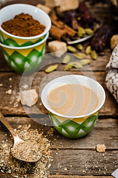 Arabian coffee with cardamon seeds - traditional coffee. Wooden background. Selective focus