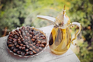 Arabian coffee in golden pot and fresh decorated dates at Ramadan and Eid fitr