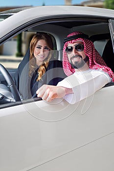 Arabian couple in a newely purchased car